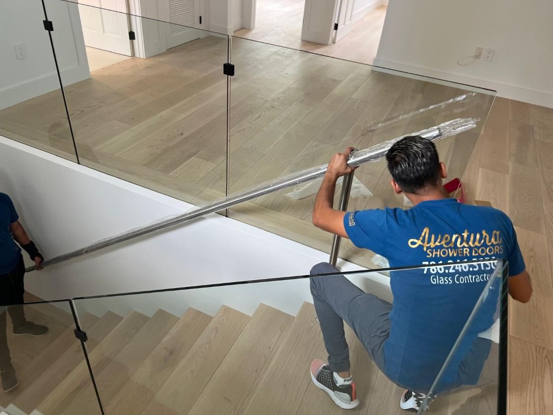 Professional technicians installing custom frameless shower doors.